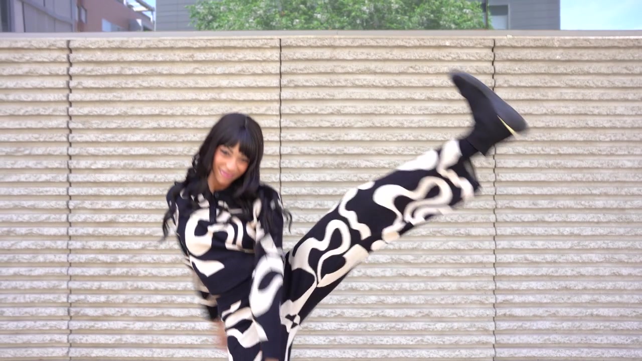 Young black woman dancing in the street