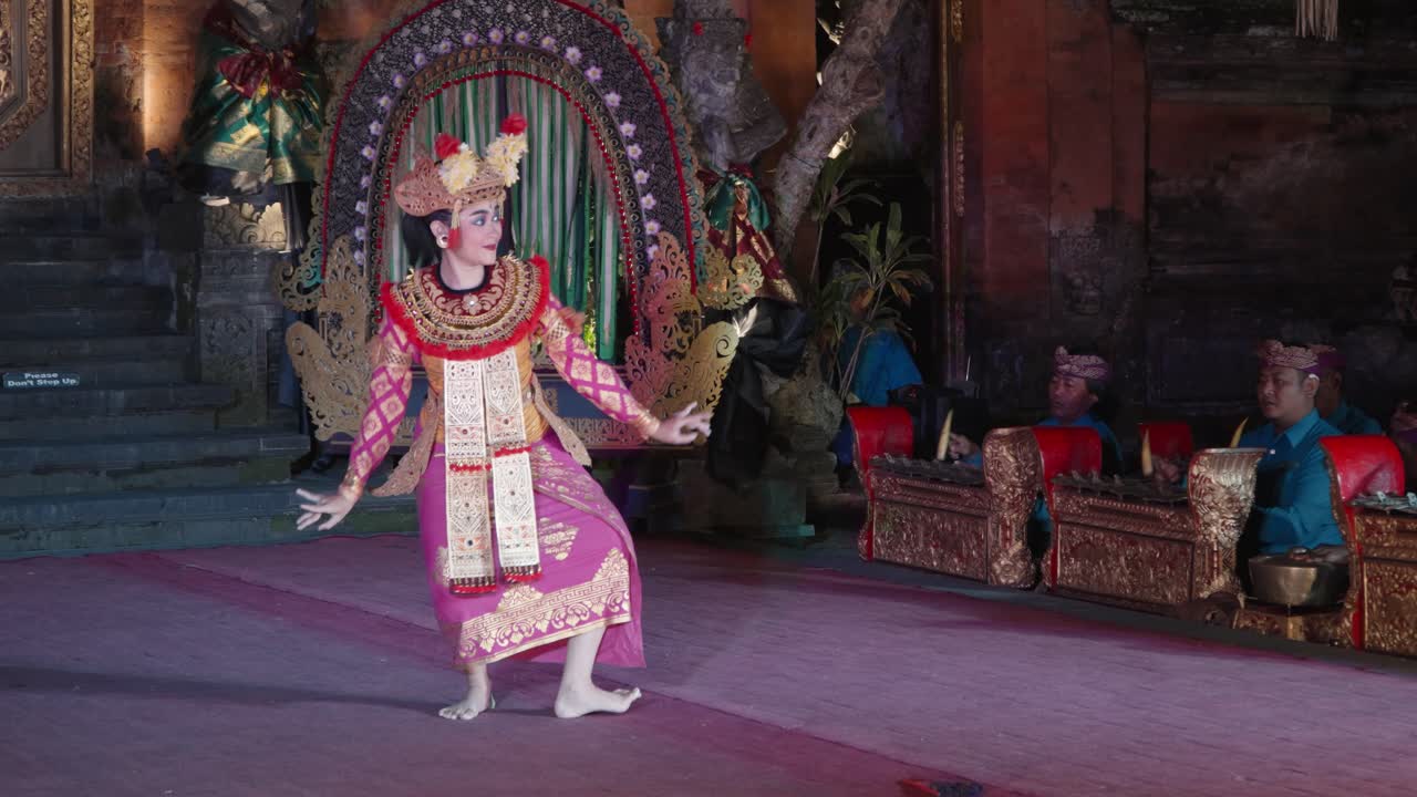 Woman Dancing Legong Dance at Ubud Palace while Group of Musicians Play on Gangsa Metallophones, Bali