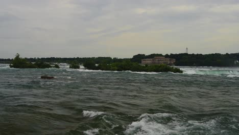 a dramatic view of the river approaching the brink of niagara falls, with mist rising high and the relentless power of nature captured from a breathtaking perspective