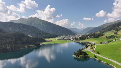 aerial drone view of kanton graubünden, schweiz- houses settlement along the kanton graubünden, schweiz lake