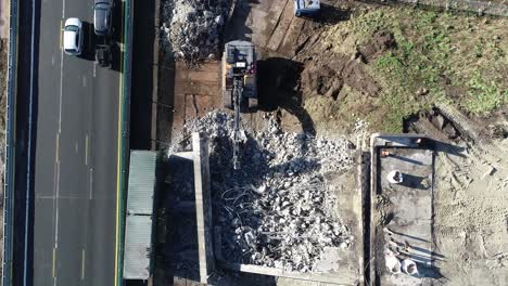 Push-in-shot-of-rubble-at-a-construction-site-next-to-a-highway