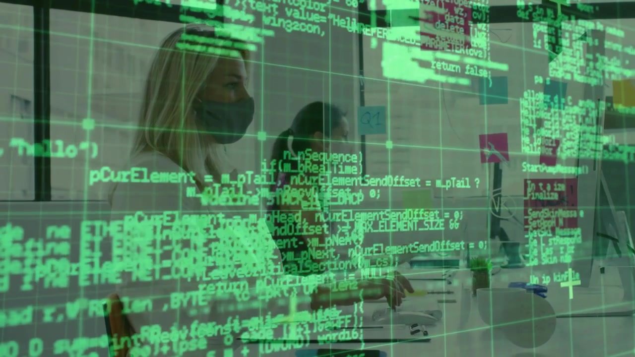 Woman typing at tech desk initiating green code overlay while coworker joining, building software