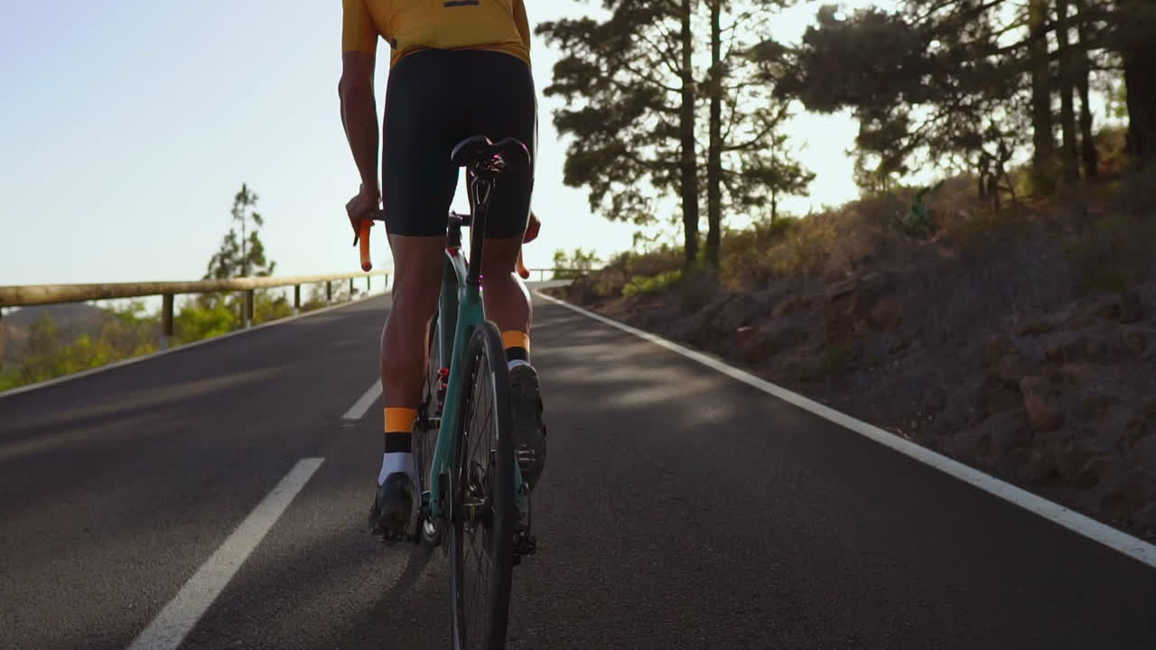 Man cycling on road bike outdoor exercise on an empty road in the morning .Extreme sport concept. slow motion