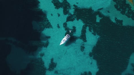 Yacht-ship-sailing-boat-at-pristine-turquoise-clear-water-beach-bay-on-Palma-de-Mallorca-Island