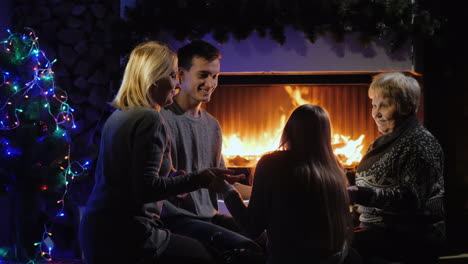 multi-generational family having fun by the fireplace