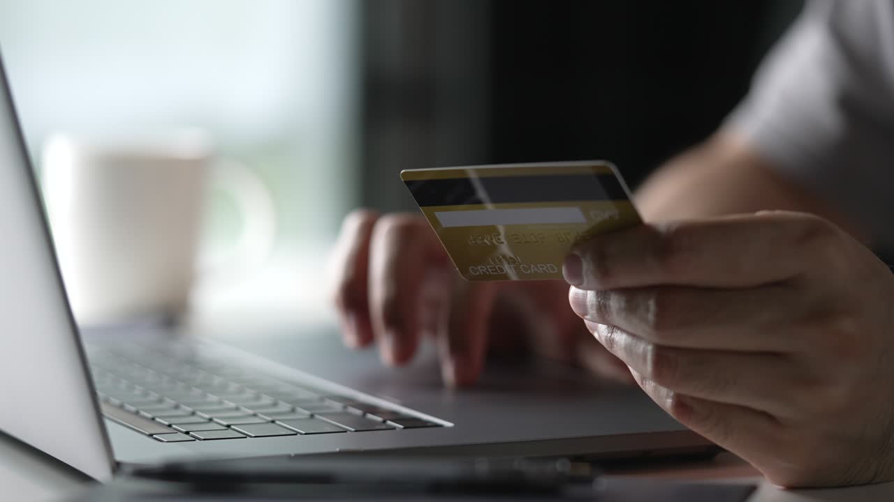 manos masculinas con tarjeta de crédito y usando una computadora portátil. compras en línea