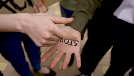 close-up of a hand with the word stop" written on it"