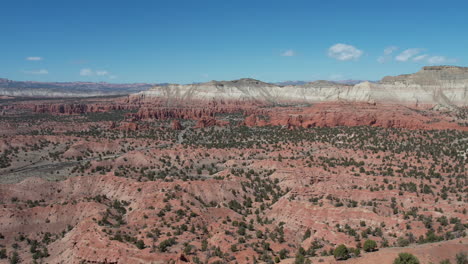 Aerial-View-of-Desert-Wilderness,-Sandstone-Hills,-Cliffs-and-Valley-on-Hot-Day