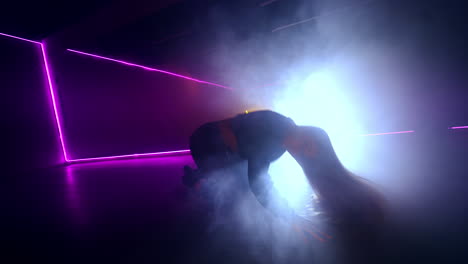dynamic breakdancing performance in a neon-lit studio