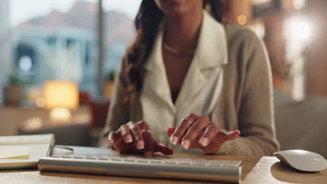 woman typing on a keyboard at her desk