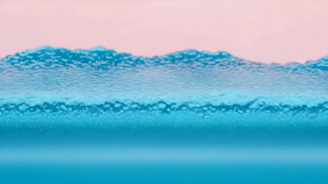 Superficie dell'acqua che si forma reagendo a una leggera ondulazione, sviluppando increspature che si espandono e una cresta spumosa.