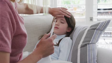 mother taking care of her sick daughter at home