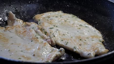 grilling chicken breasts fillets in a frying pan, focusing on texture and cooking process