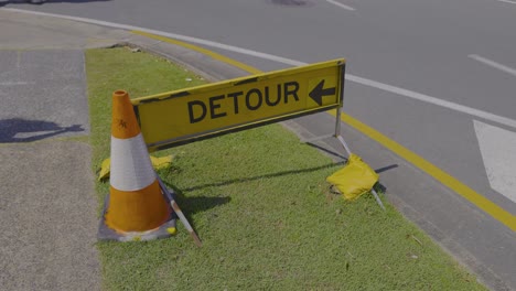 traffic detour sign with cone and umbrella