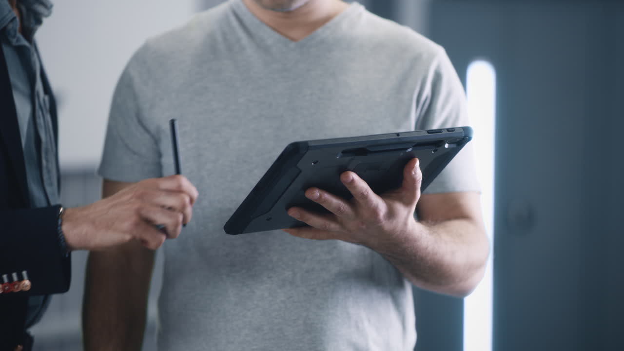 Business professionals discussing information on a digital tablet