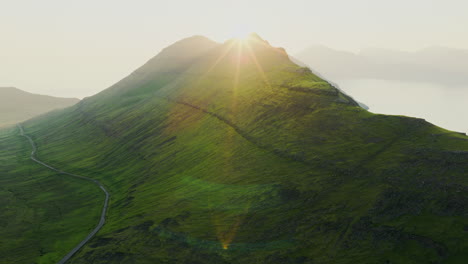 Majestic Green Mountain Landscape with Winding Road at Sunrise