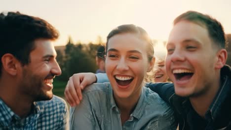 happy friends laughing together at sunset