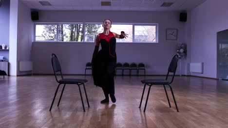 Professional-female-dancer-dances-around-two-chairs