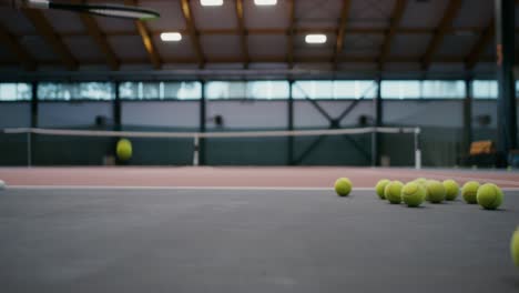 indoor tennis court with balls