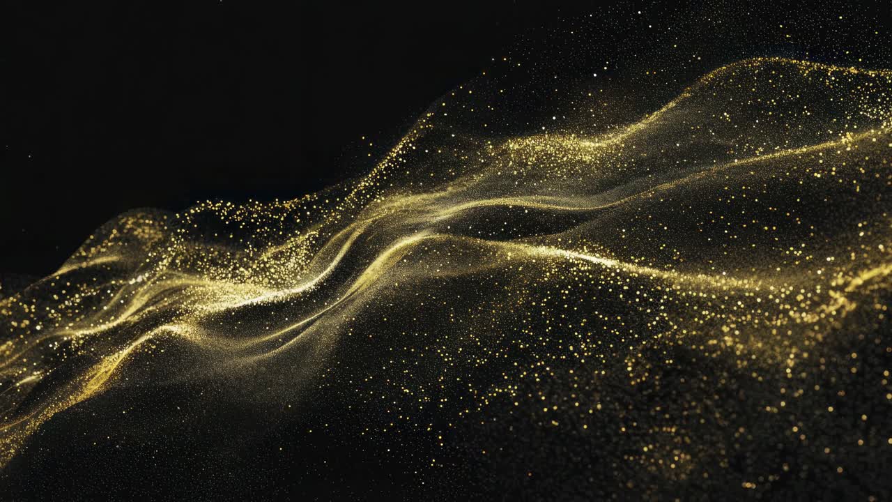 Abstract video of golden particles flowing in waves on a dark ...