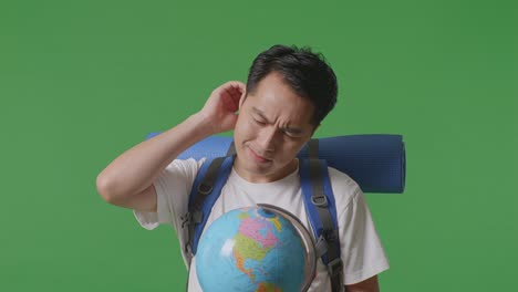 confused traveler looking at a globe