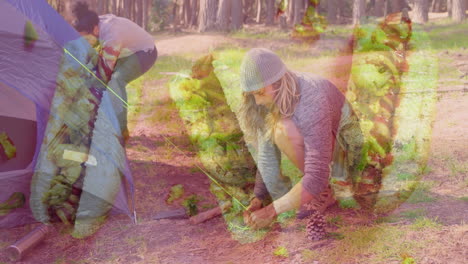 people setting up tent in forest with green foliage animation overlay