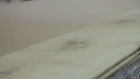 wood board is sanded down by hand in workshop factory