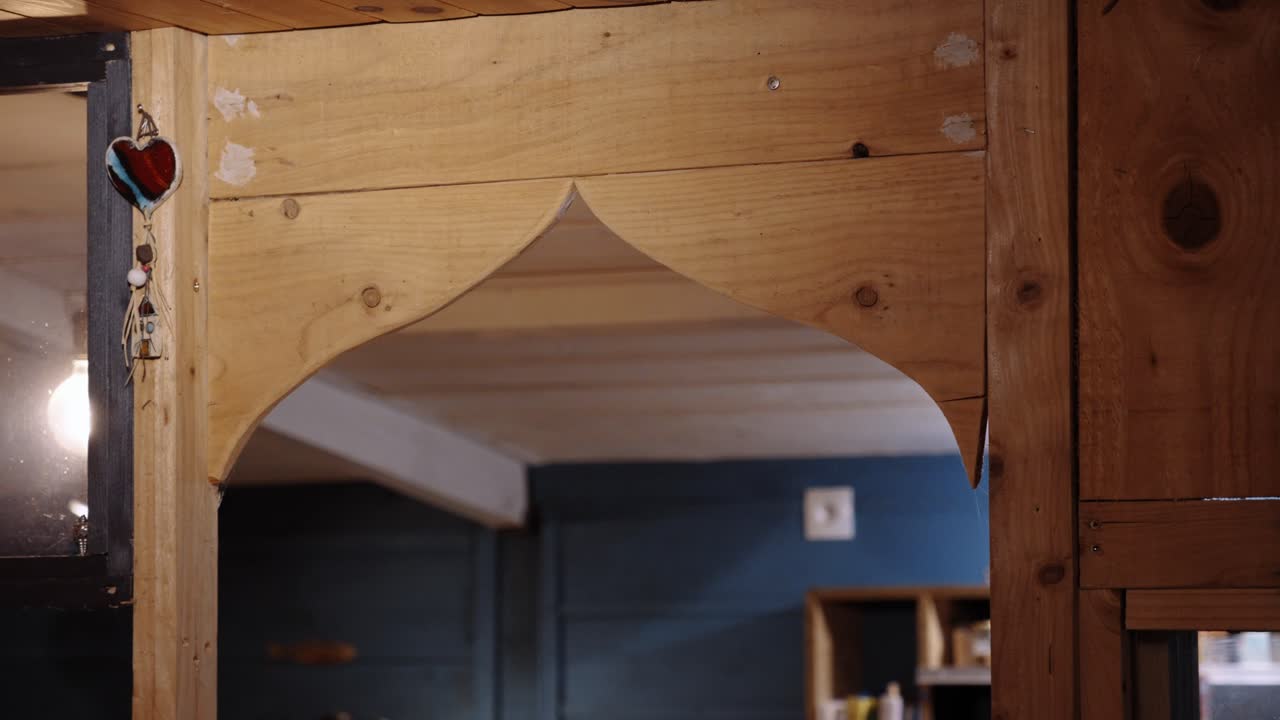 Rustic wooden archway in a cozy cabin, warm tones and craftsmanship, symbolizing tradition, comfort, and timeless design.