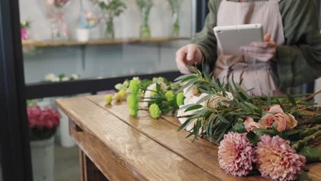 Unrecognizable Florist With Digital Tablet