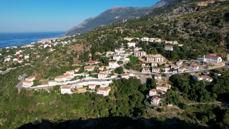 mediterranean village of dhermi nestled on mountain slope with stunning sea views – a perfect summer holiday destination in albania