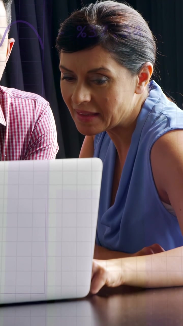 Vertical video: Woman leaning in, tapping laptop and activating purple overlays for business review