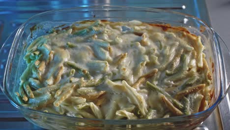 oven baked cheesy chicken and pasta in a glass baking dish