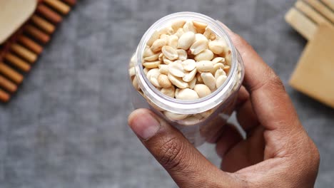 Men holding peanut jar top view