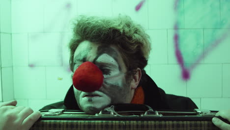 clown sitting in subway