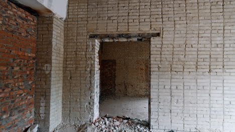 bare walls of diverse color of bricks. walking by the rooms of the house prepared for renovation.