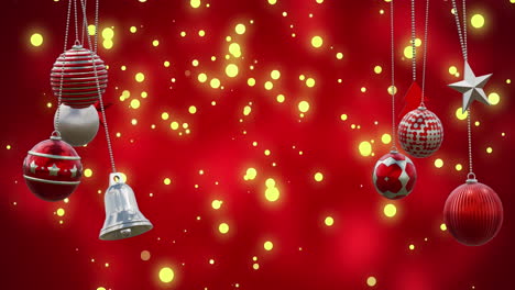 animation of christmas baubles and spots of light falling on red background