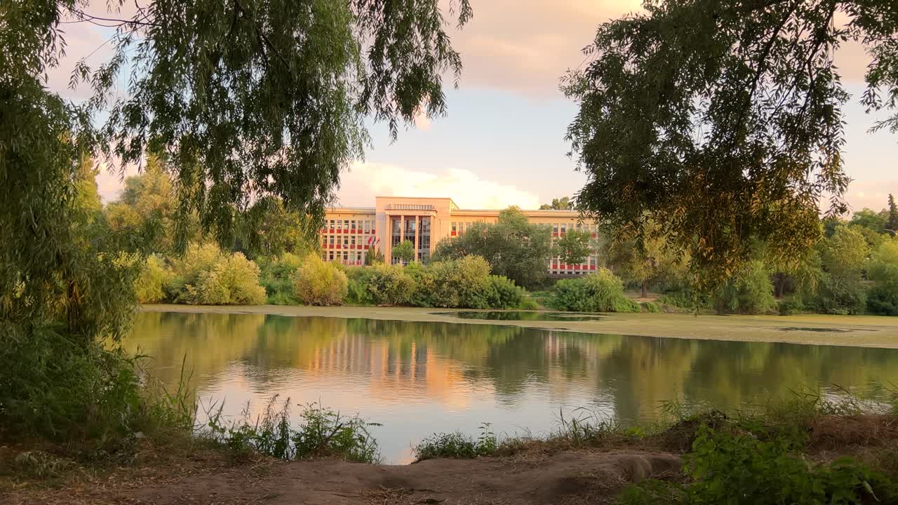 On the banks of the Maritsa River. Opposite the building of the University of Food Technology. Maritza River at sunset. Picturesque view.