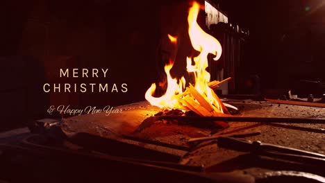 animation of merry christmas text over bonfire