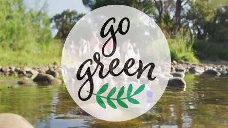 animation of go green text and logo over diverse group collecting rubbish in countryside