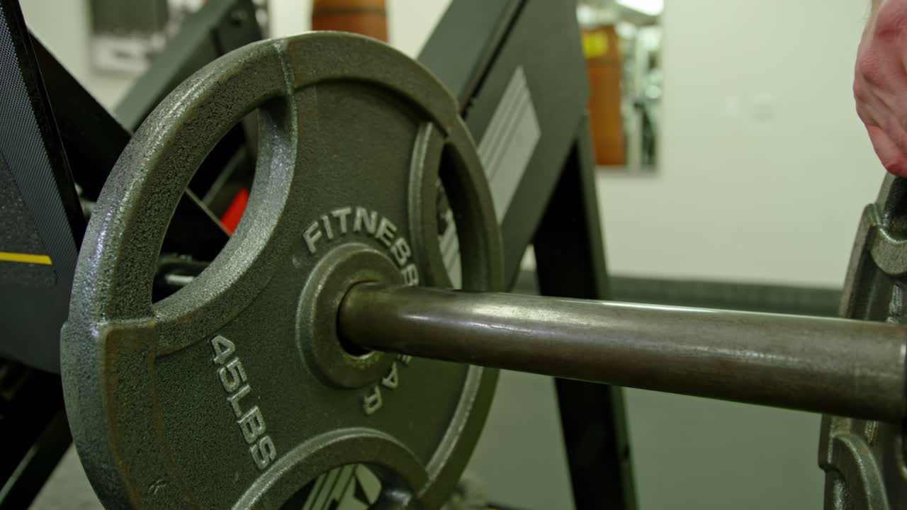 Strong bodybuilder lifting weights. Athletic person effort