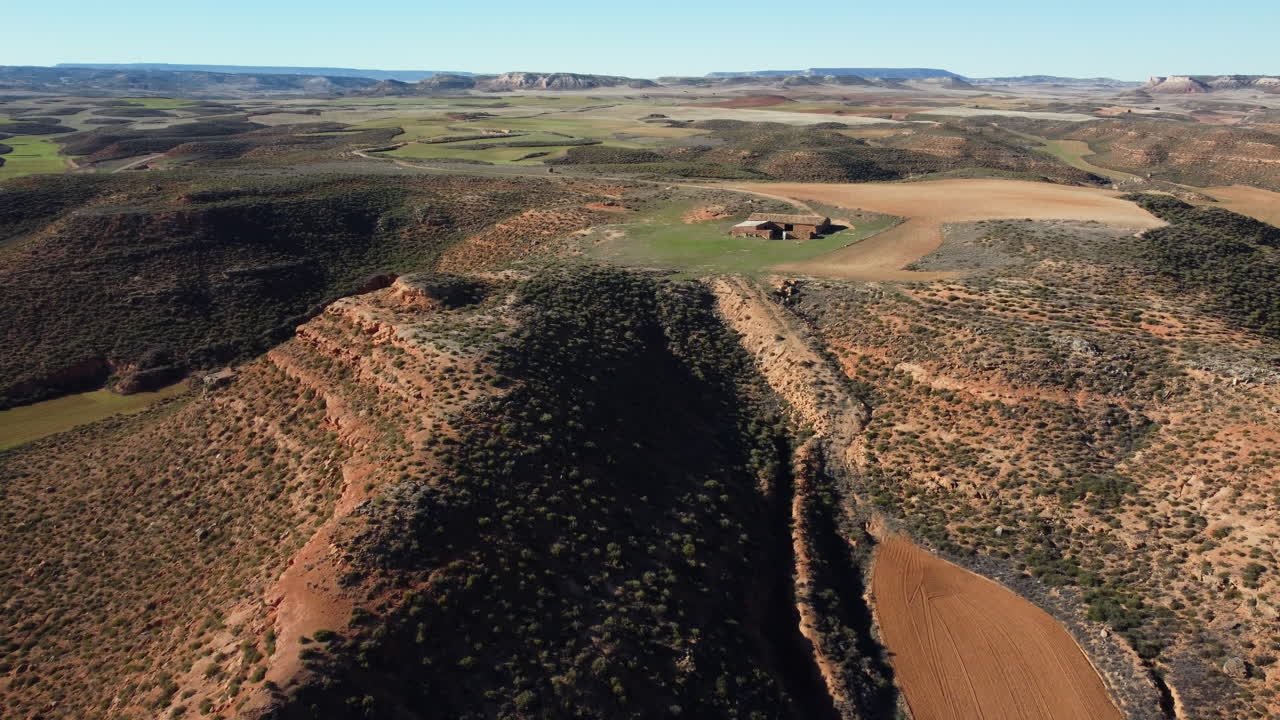 Aerial view of a Spanish rural landscape with hills, valleys, and farmland