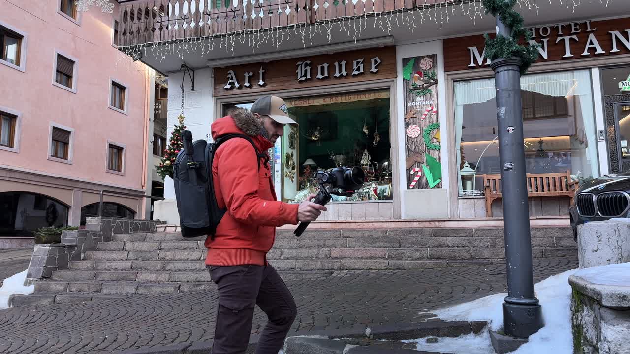 Freelancer Videographer Using Gimbal To Film Outside On Street In Cortina d'Ampezzo, Italy