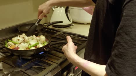 Chef-In-The-Kitchen-Cooking-Delicious-Korean-Beef-Bulgogi-In-Pan-With-Fresh-Vegetables-And-Mushrooms