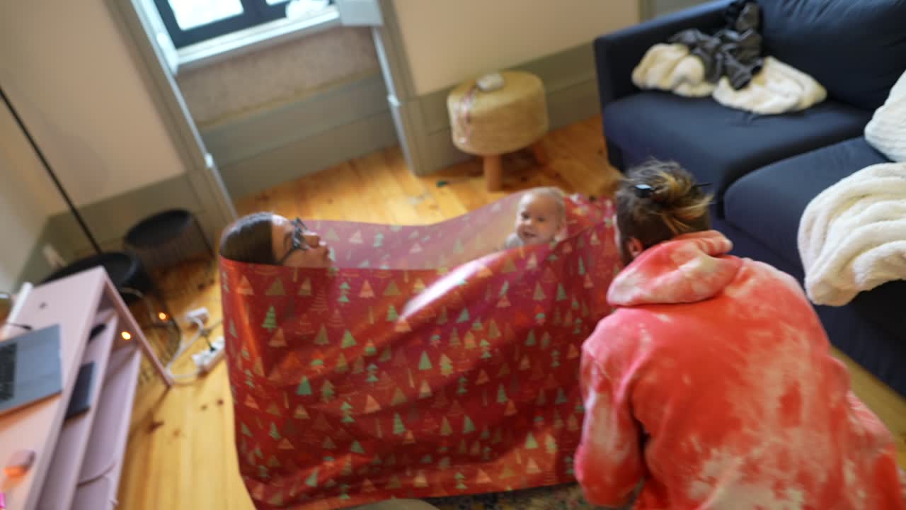 クリスマスのプレゼントを開く家族