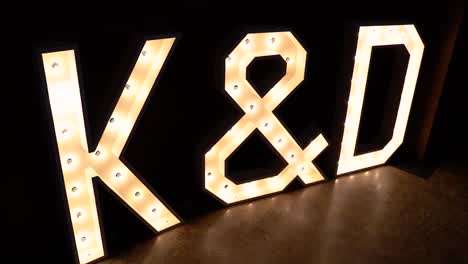 k and d letter lights at a wedding reception - slow motion