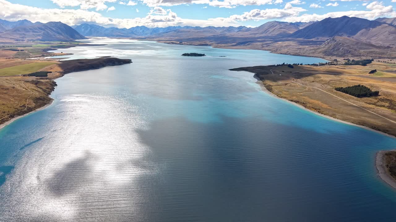Aerial view of serene Lake Tekapo in New Zealand, calm and sunny day
