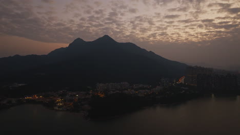 stunning view of some buildings and mountains with an amazing pink sunset
