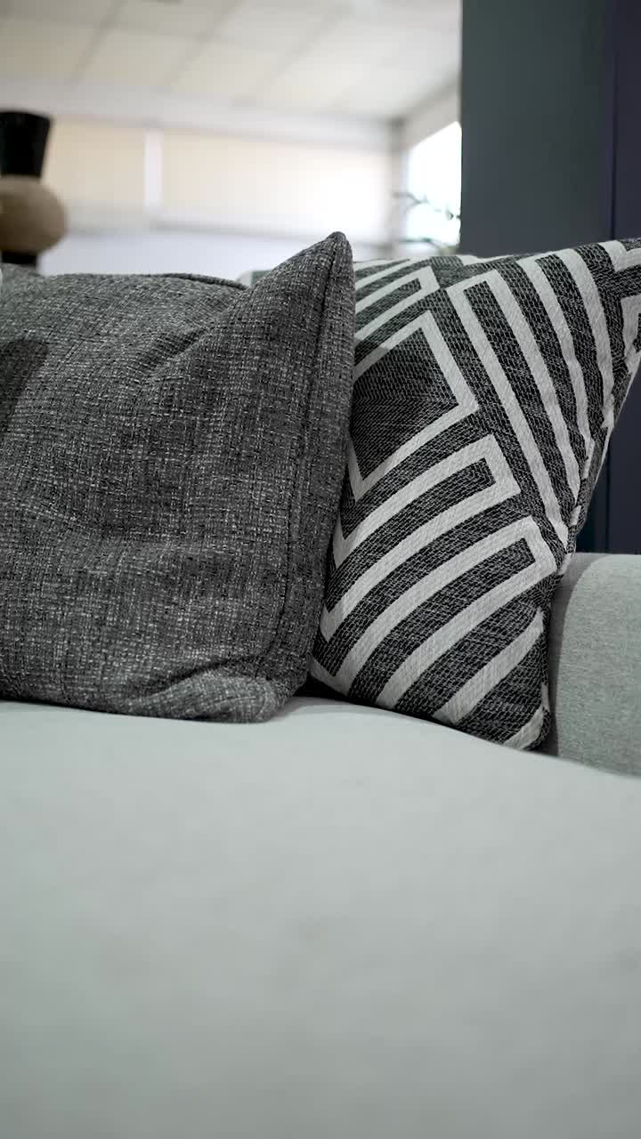 This setting highlights a cozy sofa adorned with modern pillows. The mix of textures and patterns creates a warm, inviting atmosphere perfect for relaxation
