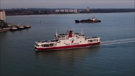 isle of wight red funnel ferry moving towards southampton. sailing from cowes. car ferry aerial shot.