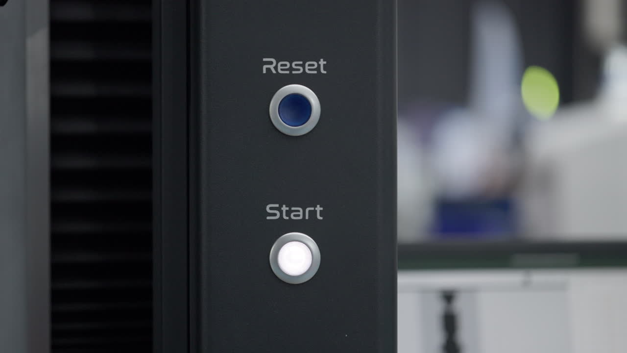 Close-up of reset and start buttons on a machine